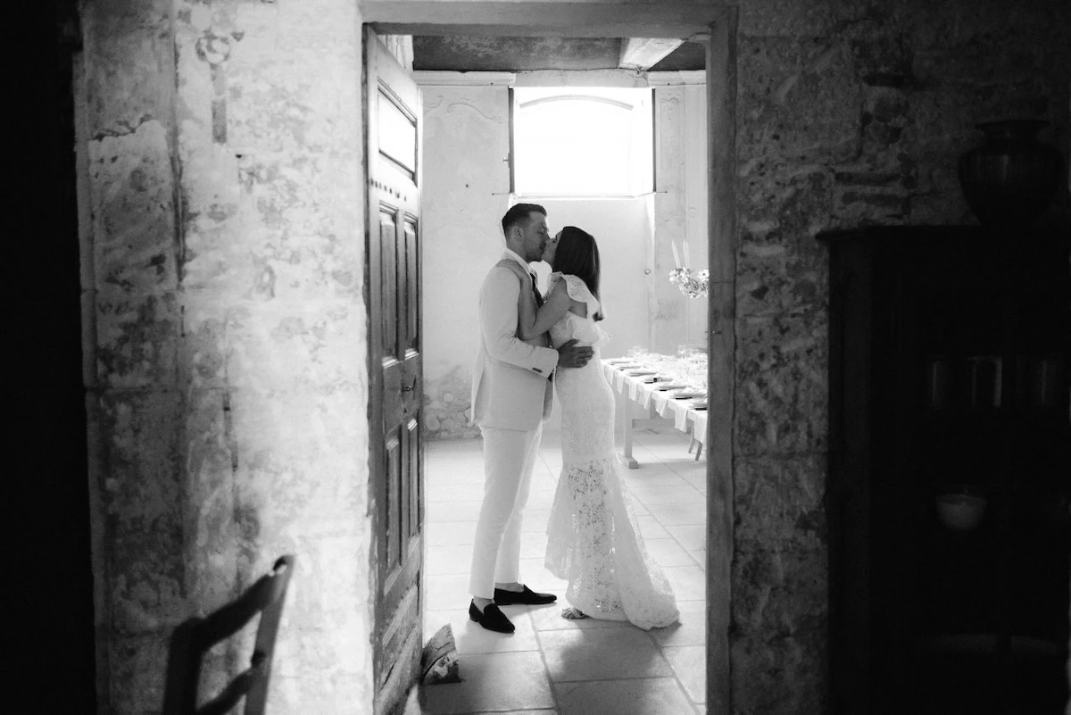 A couple of newlyweds kissing, black and white